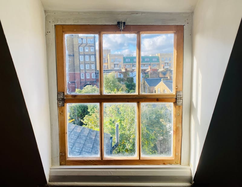 Hinged timber casement window restored, in a dormer