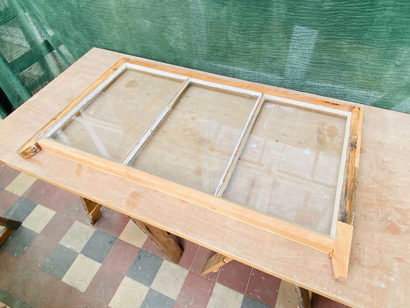 Casement on the bench in the workshop with new timber
