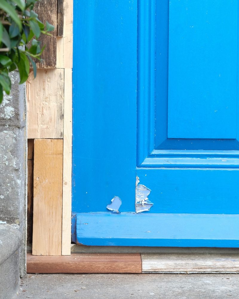 Rot cut out of the door frame, with a new hardwood threshold and the first new timber let in