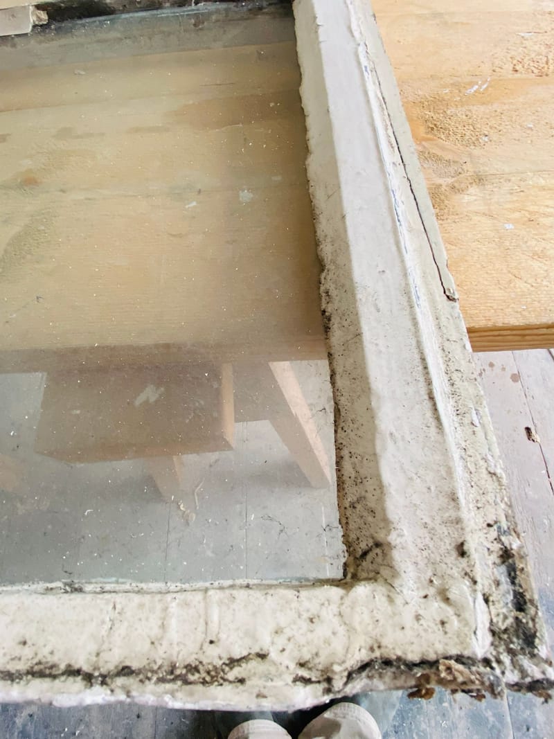 Old cracked putty on a sash before repair