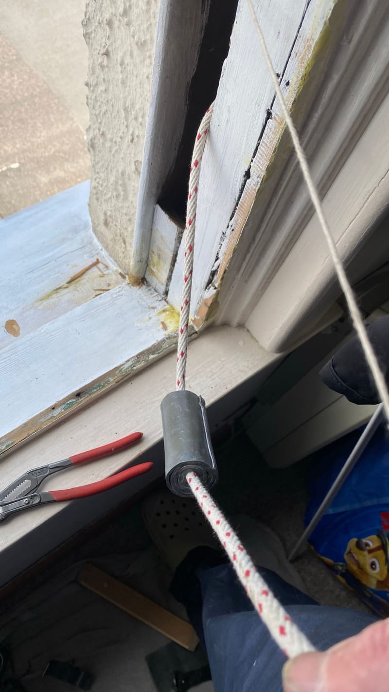 A lead weight being added to a sash cord to balance the window