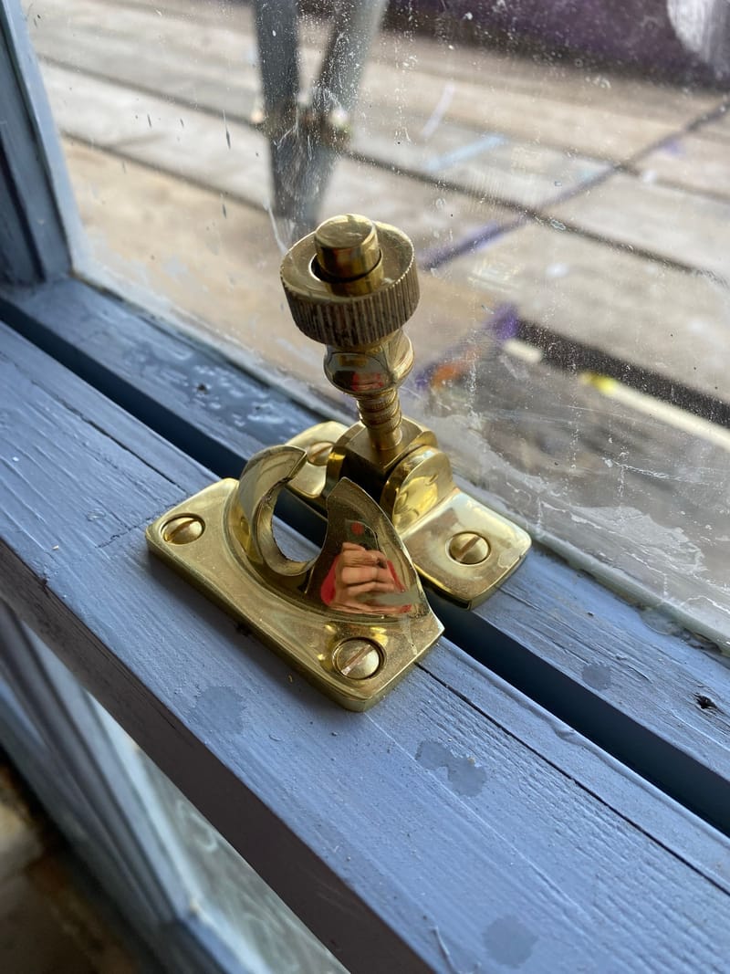 Brass sash fastener on a restored sash