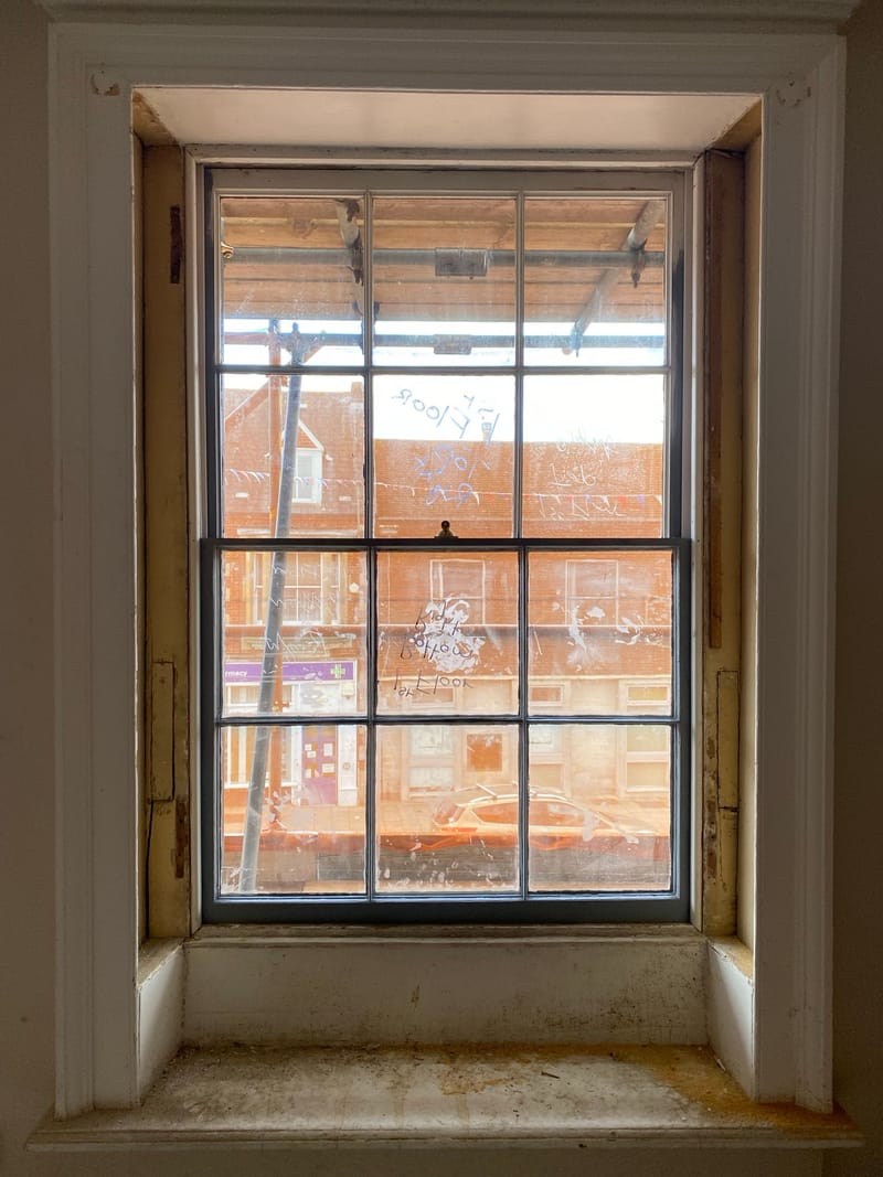 Restored sash window seen from inside, in its panelled reveal