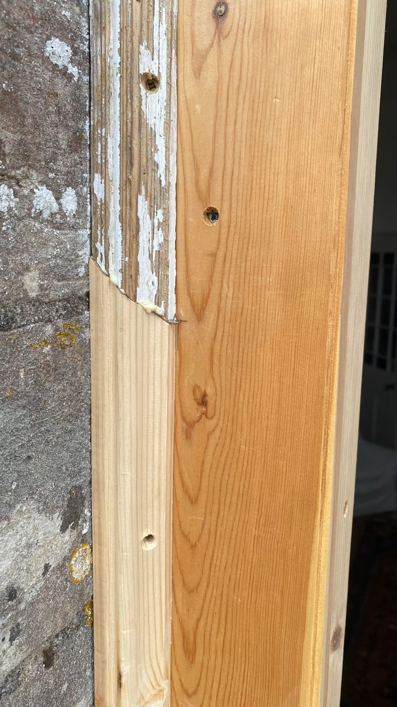 Long splice of new timber in an old door frame