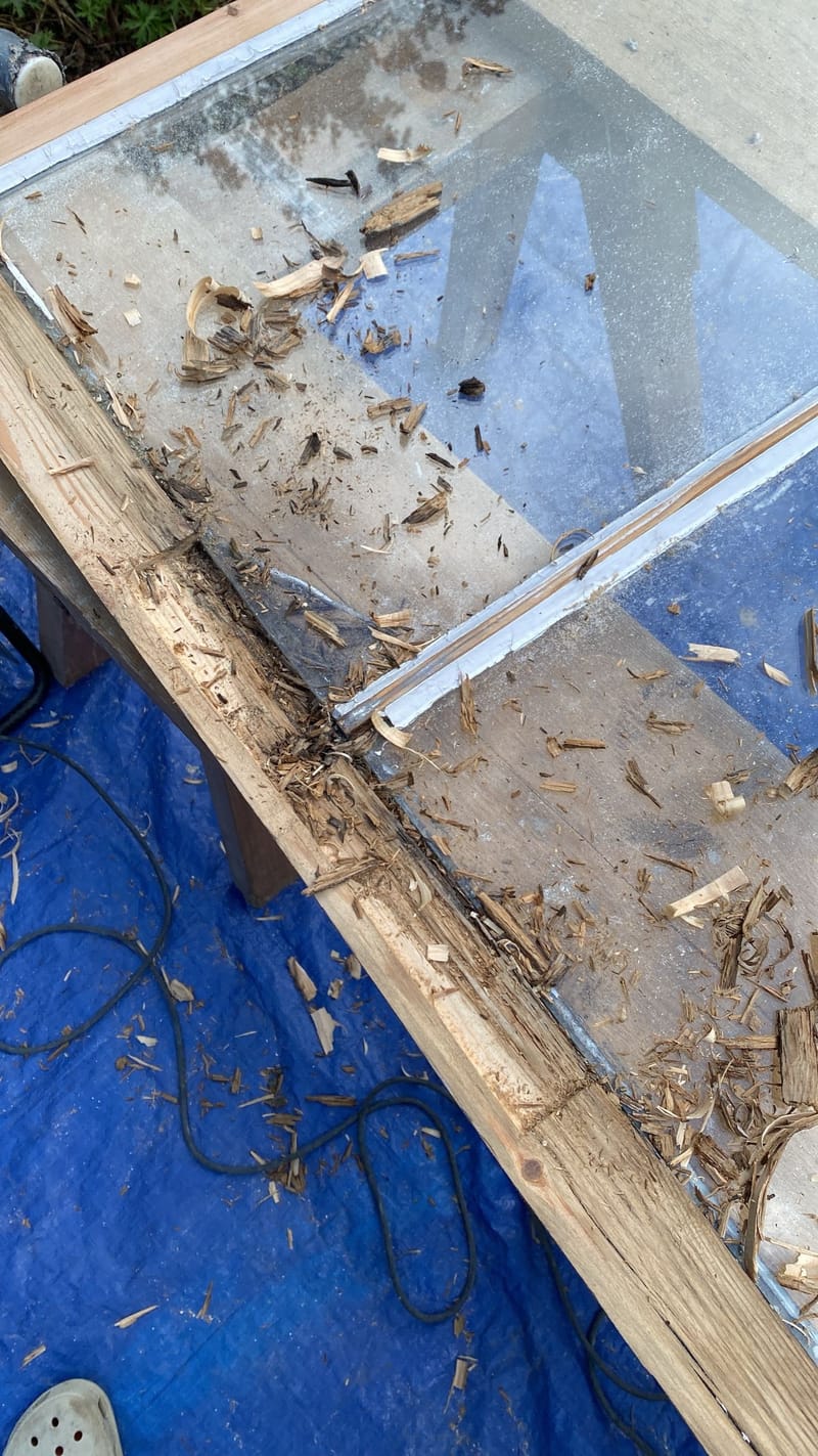 Rotten timber being cut out of a sash rail on the bench