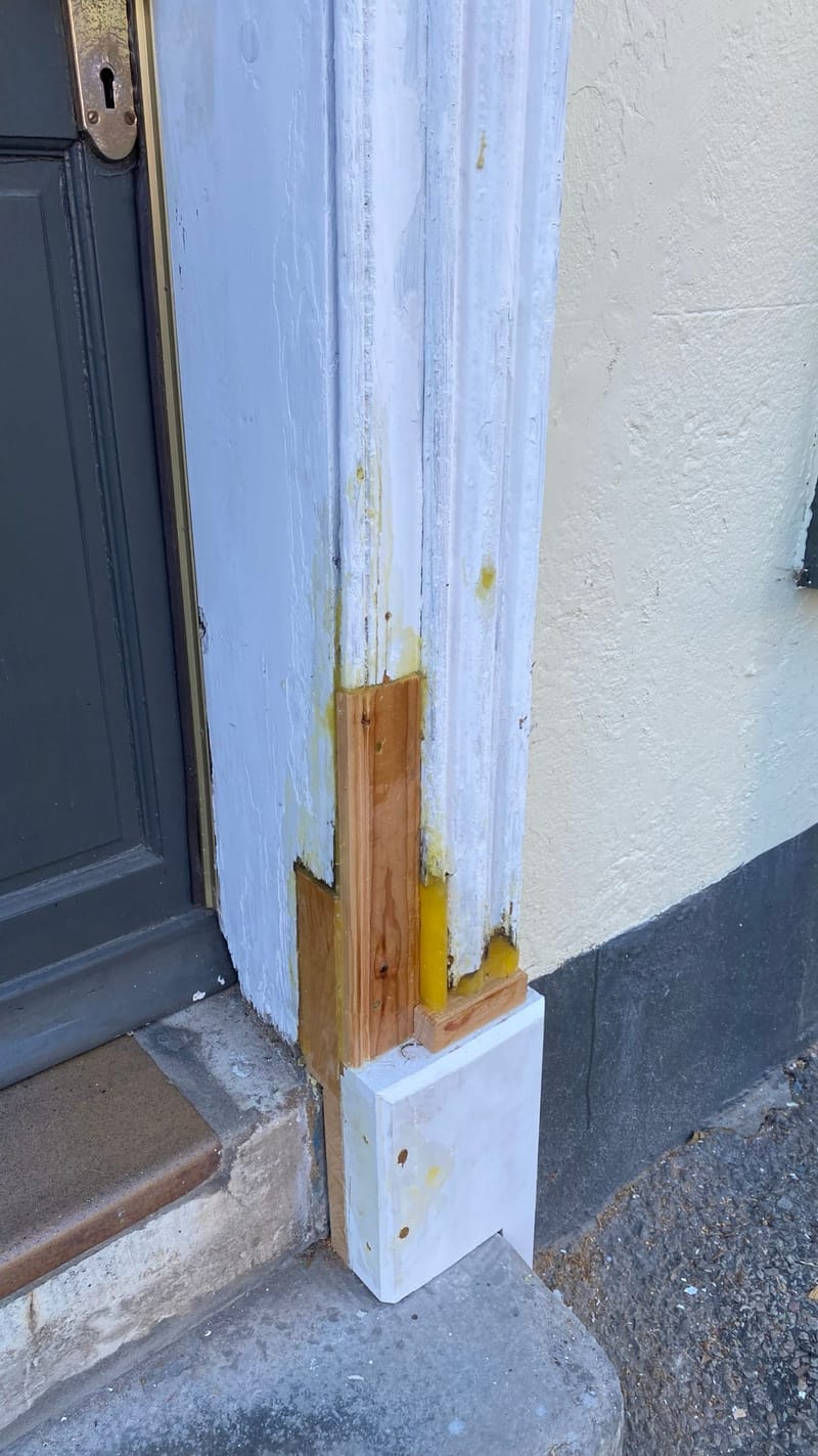 Doorcase pilaster with new timber spliced in and resin repairs, before painting
